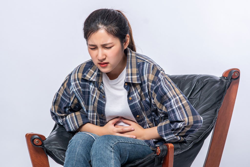 Woman experiencing abdominal discomfort